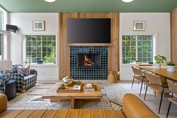 A living room with a fireplace and a flat screen tv.